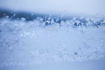 Fototapeta na wymiar Abstract frosty pattern on glass. Winter season background.