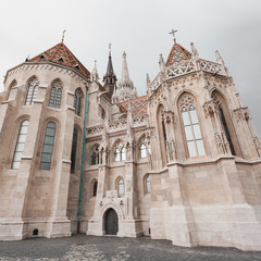 Naklejka premium St. Matthias Church in the Fisherman's Bastion in Budapest, Hungary. Cloudy weather, dramatic sky