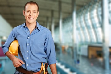 Young man worker in uniform with yellow