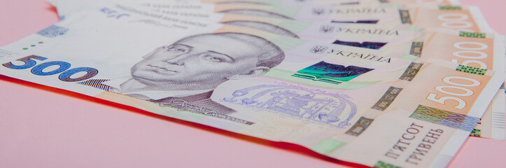 Fototapeta premium Modern Ukrainian money on pink background - hryvnia . 500 banknotes. UAH. Money concept