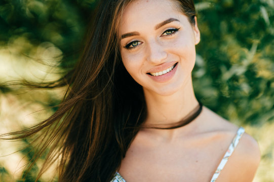Closeup lifestyle portrait of celebrity female model.  Beautiful girl face on abstract nature background. Cheerful amazing young woman face expression. Sexy blue eyed babe. Glamour youth appearance.