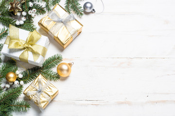 Christmas background with gold and silver decorations on white.