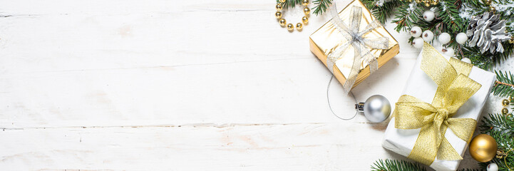 Christmas background with gold and silver decorations on white.