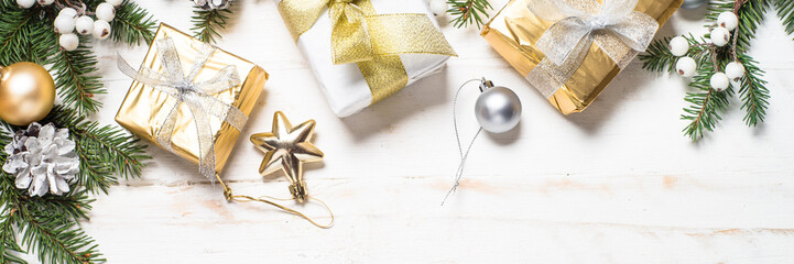 Christmas background with gold and silver decorations on white.