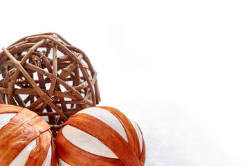 Christmas balls or christmas decoration made of natural eco friendly materials in front of white snowy background for use as a christmas card template with copy space
