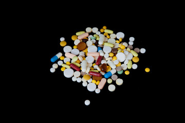 The pills are scattered on a black background. Tablets are scattered. Placebo