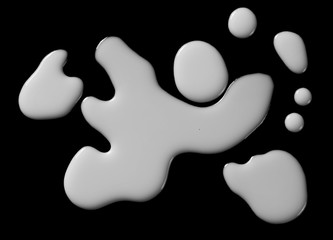 Spilled milk puddle isolated on black background and texture with clipping path, top view