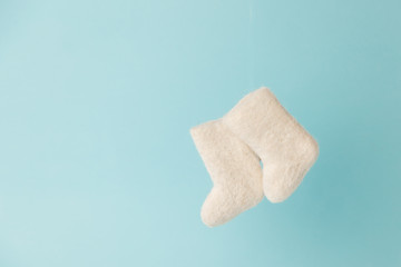 woolen warm winter shoes valenki on a blue background. the concept of winter. winter shoes