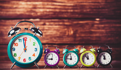 Retro alarm clocks on a table. Photo in retro color image style