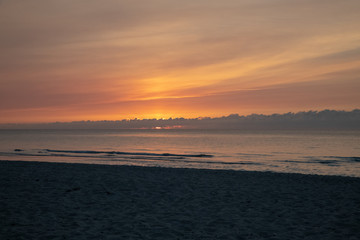waves on the beach in the ocean at sunset