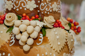 Bread, decorated with flowers and grapes from the dough. Pastry for solemn events