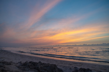 Fototapeta na wymiar waves on the beach in the ocean at sunset