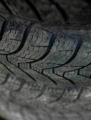 Winter tires close-up . Tyre background. Tire stack background