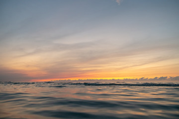 waves on the beach in the ocean at sunset