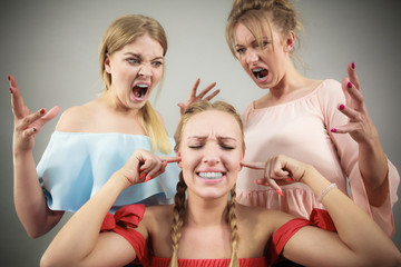 Woman being bullied by two females