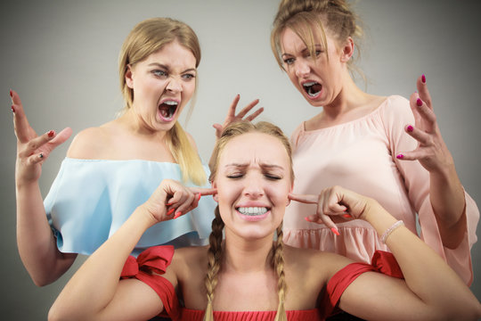 Woman being bullied by two females