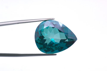 Macro image of a polished teardrop-shaped topaz gem