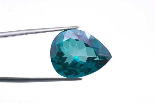 Macro image of a polished teardrop-shaped topaz gem