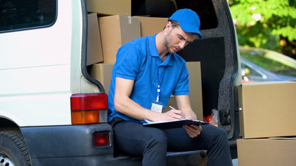 Busy delivery workman counting parcels, stocktaking checklist, part-time job