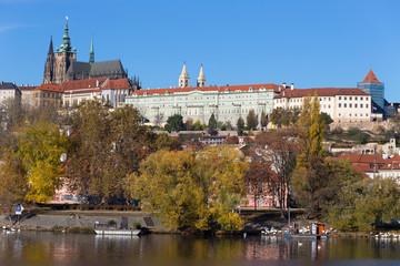 Fototapeta premium Colorful autumn Prague gothic Castle with the Lesser Town above River Vltava in the sunny Day, Czech Republic