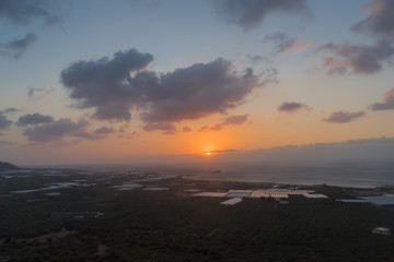 Fototapeta premium Gramvousa Peninsula, Crete - 09 25 2018: Phalassarna. Sunset on the greenhouses fields