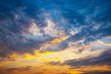 Fototapeta na wymiar Orange light and dark clouds on sky before sunset in the evening...