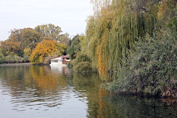 Fototapeta na wymiar Colorful trees reflecting in the water. Beautiful autumn day. 