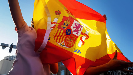 Spanish fans jumping with flag, celebrating victory of national football team
