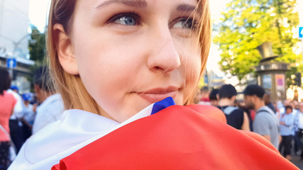 Beautiful young woman with national flag smiling, independence day celebration