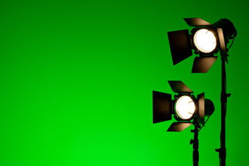 Equipment for photo studios and fashion photography. Green copyspace, lens flare effect