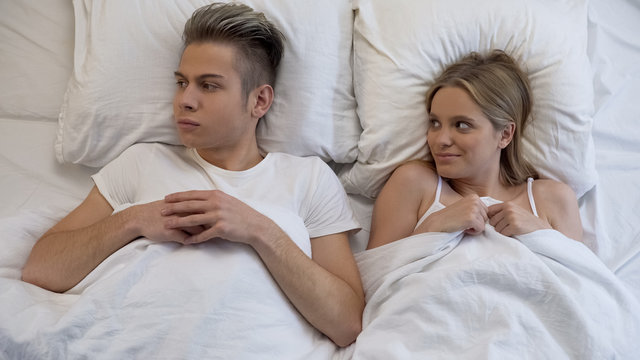 Insecure young man feeling scared before first sex with girlfriend, panic