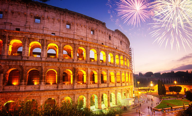 Fototapeta na wymiar view of Colosseum illuminated at night with fireworks in Rome, Italy