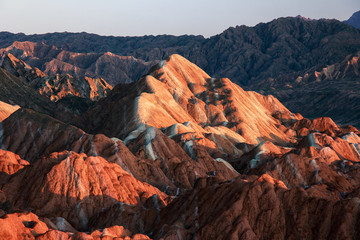 Obraz premium Zhangye Danxia National Geopark - Gansu Province, China. Chinese Danxia multicolor danxia landform, rainbow hills, unusual colored rocks, sandstone erosion, layers of Red, Yellow and Orange stripes.