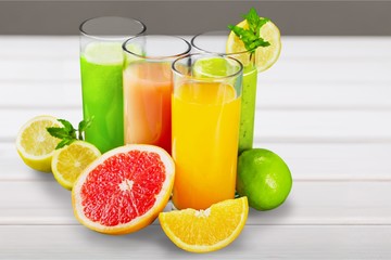 Tasty fruits  and juice with vitamins on background