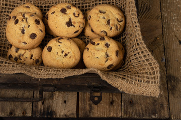 Cookies tied with a gray jute string into a bow. Cookies of sweets on a wooden kitchen table.