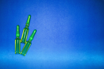 Vaccine ampoules on a blue background. Vaccine concept for child