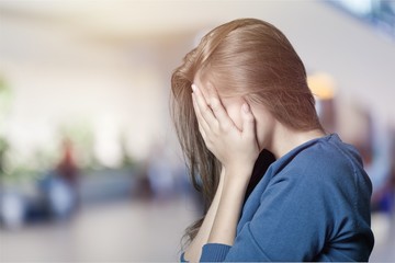 Young woman crying on background