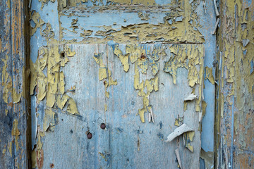Paint-peeling wooden old door texture detail