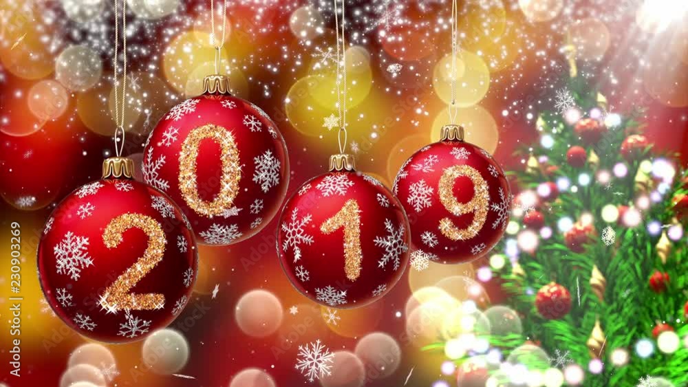 Wall mural red balls with numbers 2019 hanging on the background of a gold bokeh and a rotating christmas tree 