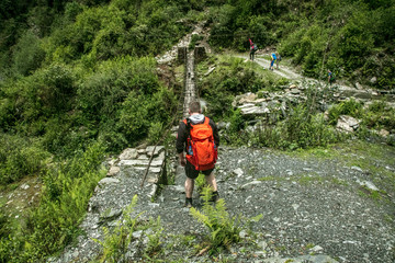 wanderer before damaged bridge in nepal