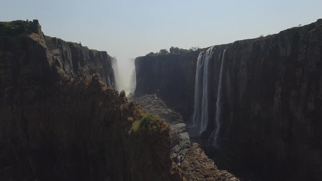 Spectacular Aerial shot inside the canyon of Victoria Falls in Zambia, falls and river during Dry Season