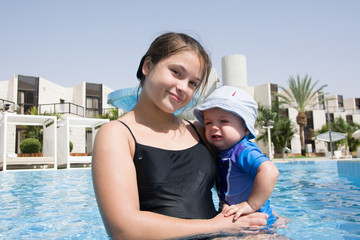 Fototapeta na wymiar Happy brother and sister play in swimming pool, Healthy and exercise concept