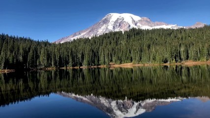 Beautiful Fall day in Mt. Rainier National Park in Washington State.  Slow pan from left to right of Mount Rainier with its reflection in one of the Reflection Lakes