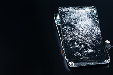 closeup broken phone on black background repairing phones