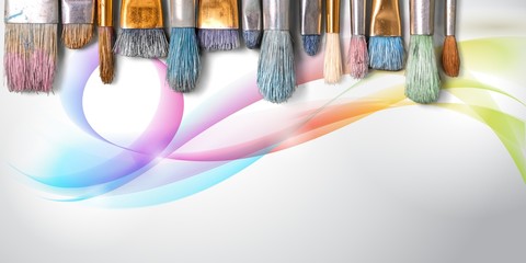 Row of artist paint brushes on background