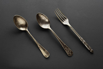 old cutlery on gray background