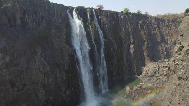 Beautiful fall and rainbow inside the canyon at Victoria falls, drone view