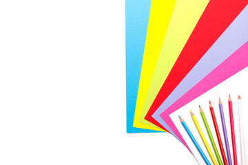 Colourful Paper and pencils isolated on white copy space top view