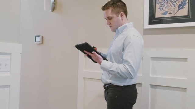 Home inspector using a tablet to complete his work assignment