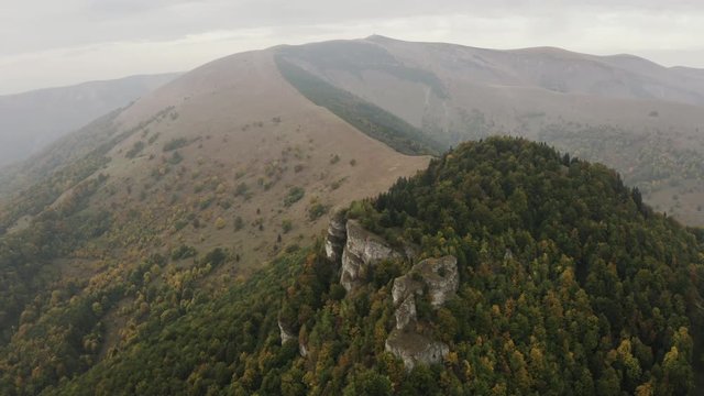 Aerial shot of rock formation on autumn forest peak, Slovakia